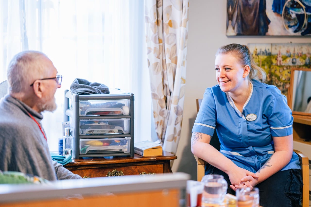 Care worker talking with a resident in a care home